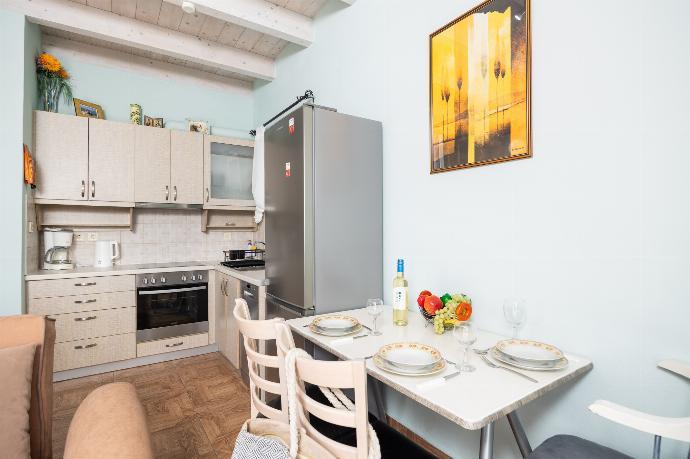 Open-plan living room with sofas, dining area, kitchen, A/C, WiFi internet, satellite TV, and sea views . - Villa Magda Dione . (Photo Gallery) }}