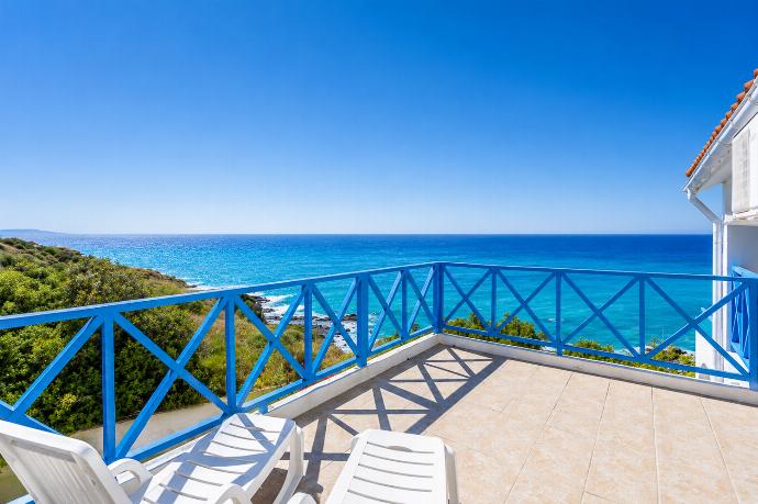 Private balcony with sun loungers, bright blue railings, and breathtaking sea views. . - Panorama Villa . (Photo Gallery) }}