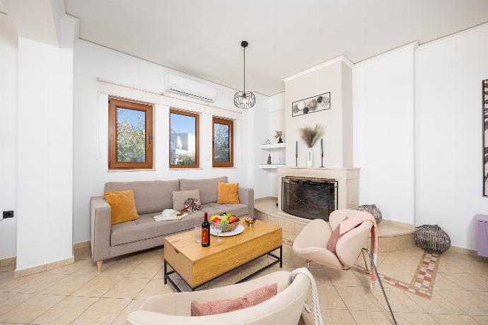 Living room with sofa, ornamental fireplace, A/C, WiFi internet, and satellite TV . - Villa Aspa . (Photo Gallery) }}