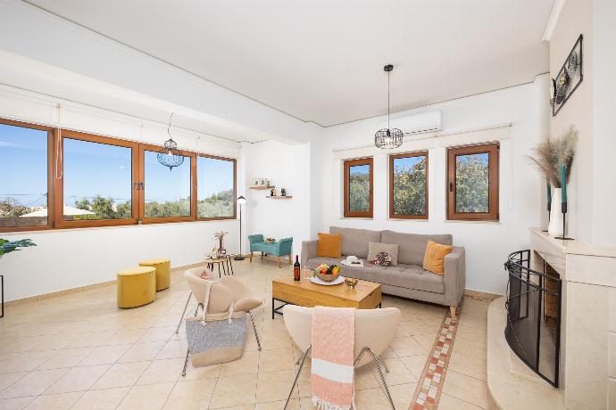 Living room with sofa, ornamental fireplace, A/C, WiFi internet, and satellite TV . - Villa Aspa . (Photo Gallery) }}