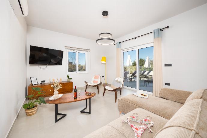 Living room with sofa, dining area, A/C, WiFi internet, and satellite TV . - Villa Filia . (Photo Gallery) }}