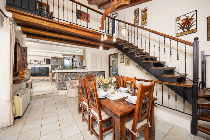 Open-plan living room with sofas, dining areas, kitchen, ornamental fireplace, A/C, WiFi internet, and satellite TV . - Aloni Villa . (Photo Gallery) }}