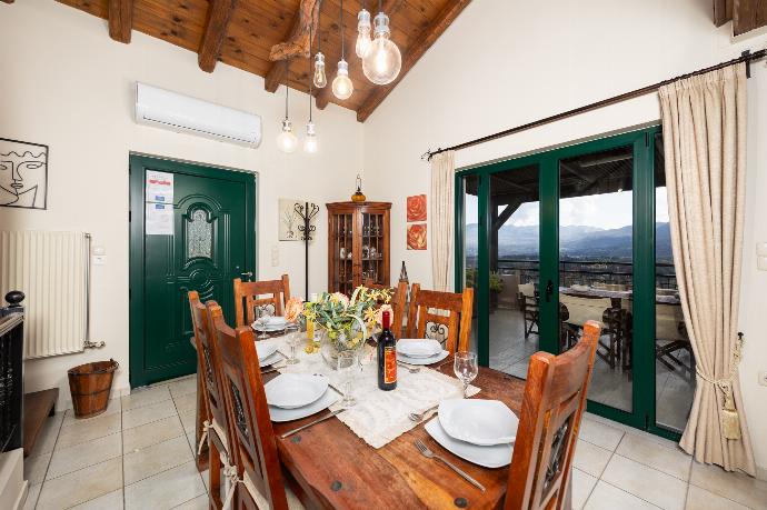 Open-plan living room with sofas, dining areas, kitchen, ornamental fireplace, A/C, WiFi internet, and satellite TV . - Aloni Villa . (Photo Gallery) }}