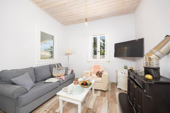 Open-plan living room with sofa, dining area, kitchen, ornamental fireplace, WiFi internet, and satellite TV . - Villa Socrates . (Photo Gallery) }}