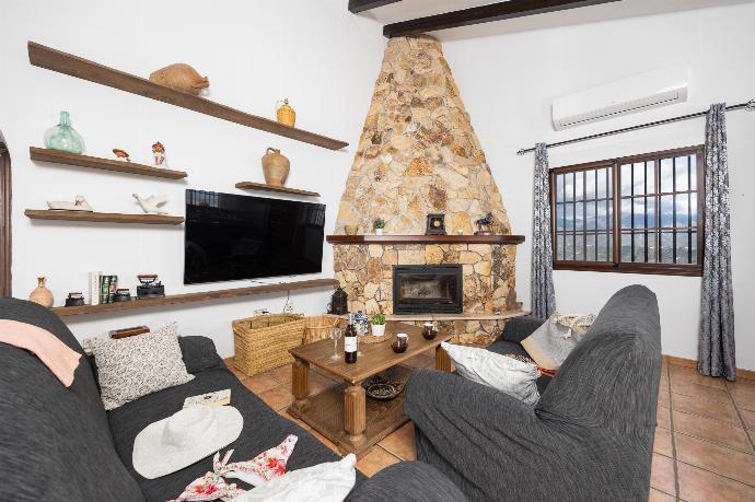 Open-plan living room with sofas, dining area, kitchen, ornamental fireplace, A/C, WiFi internet, and satellite TV . - Villa Baena . (Photo Gallery) }}
