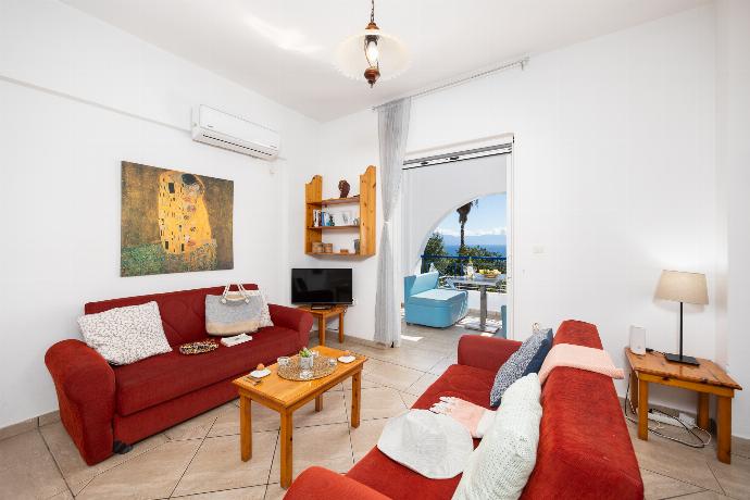 Open-plan living room with sofas, dining area, kitchen, A/C, WiFi internet, satellite TV, and sea views . - Villa Cleo . (Photo Gallery) }}