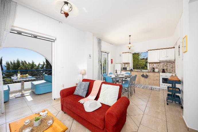 Open-plan living room with sofas, dining area, kitchen, A/C, WiFi internet, satellite TV, and sea views . - Villa Cleo . (Photo Gallery) }}