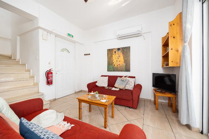 Open-plan living room with sofas, dining area, kitchen, A/C, WiFi internet, satellite TV, and sea views . - Villa Cleo . (Photo Gallery) }}