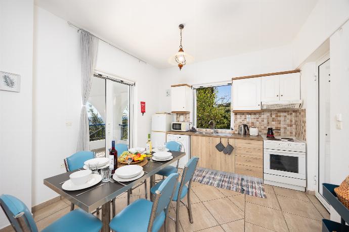 Open-plan living room with sofas, dining area, kitchen, A/C, WiFi internet, satellite TV, and sea views . - Villa Cleo . (Photo Gallery) }}