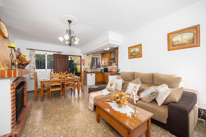 Open-plan living room with sofa, dining area, kitchen, ornamental fireplace, A/C, WiFi internet, and satellite TV . - Villa Alvarez . (Photo Gallery) }}