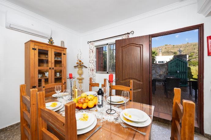 Open-plan living room with sofa, dining area, kitchen, ornamental fireplace, A/C, WiFi internet, and satellite TV . - Villa Alvarez . (Photo Gallery) }}