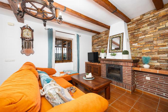 Open plan living room with sofa, dining area, kitchen, ornamental fireplace, A/C, WiFi internet, and satellite TV . - Villa Los Naranjos . (Photo Gallery) }}