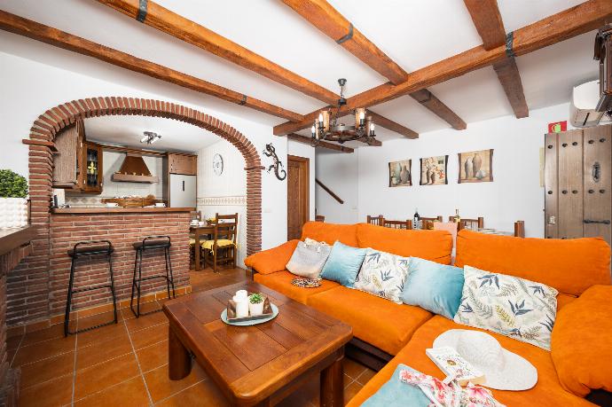 Open plan living room with sofa, dining area, kitchen, ornamental fireplace, A/C, WiFi internet, and satellite TV . - Villa Los Naranjos . (Photo Gallery) }}