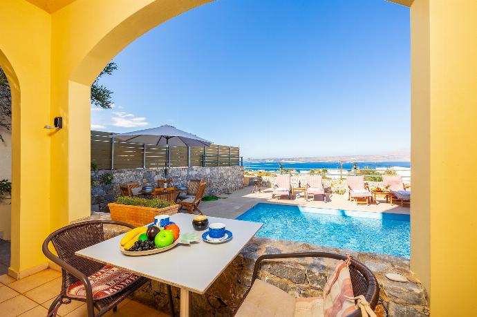 Sheltered terrace area with sea views . - Villa Aphrodite . (Photo Gallery) }}