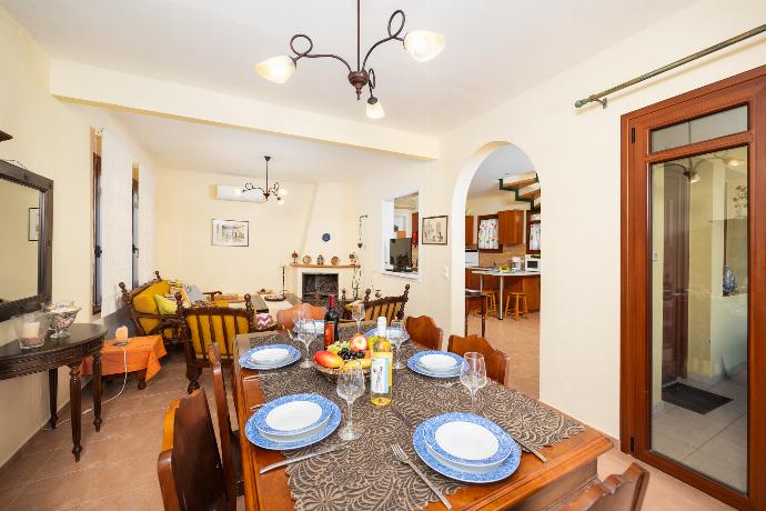 Living room with sofa, dining area, ornamental fireplace, A/C, WiFi internet, and sea views . - Villa Aphrodite . (Photo Gallery) }}