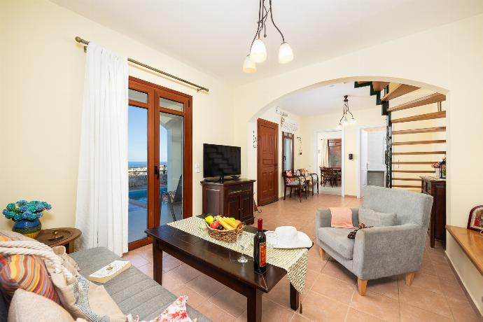 Living room with sofa, ornamental fireplace, A/C, WiFi internet, and satellite TV . - Odysseus Villa . (Photo Gallery) }}