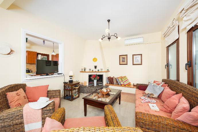 Living room with sofa, dining area, ornamental fireplace, A/C, WiFi internet, and satellite TV . - Ariadne Villa . (Photo Gallery) }}