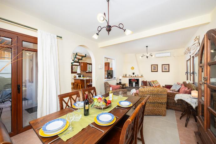 Living room with sofa, dining area, ornamental fireplace, A/C, WiFi internet, and satellite TV . - Ariadne Villa . (Photo Gallery) }}