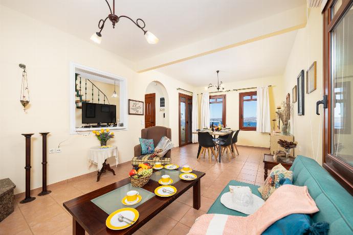 Living room with sofa, dining area, ornamental fireplace, A/C, WiFi internet, and satellite TV . - Villa Persephone . (Photo Gallery) }}