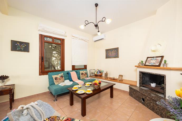 Living room with sofa, dining area, ornamental fireplace, A/C, WiFi internet, and satellite TV . - Villa Persephone . (Photo Gallery) }}