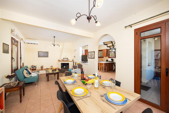 Living room with sofa, dining area, ornamental fireplace, A/C, WiFi internet, and satellite TV . - Villa Persephone . (Photo Gallery) }}