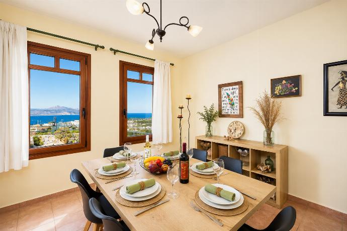 Living room with sofa, dining area, ornamental fireplace, A/C, WiFi internet, and satellite TV . - Villa Persephone Thalassa . (Γκαλερί Φωτογραφιών) }}