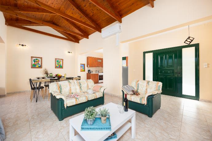 Open-plan living room with sofas, dining area, kitchen, ornamental fireplace, A/C, WiFi internet, and satellite TV . - Villa Iris . (Photo Gallery) }}