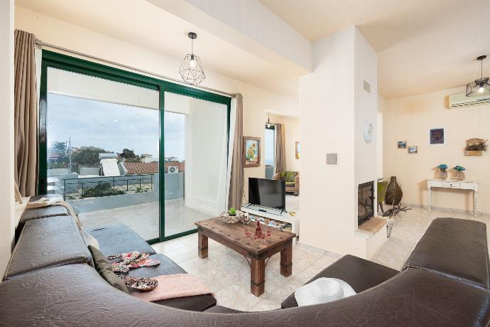 Open-plan living room with sofa, dining area, ornamental fireplace, A/C, WiFi internet, and satellite TV . - Villa Yvonne . (Photo Gallery) }}