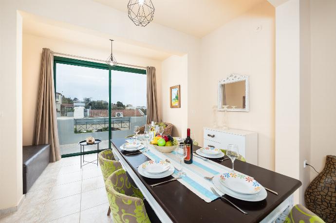 Open-plan living room with sofa, dining area, ornamental fireplace, A/C, WiFi internet, and satellite TV . - Villa Yvonne . (Photo Gallery) }}