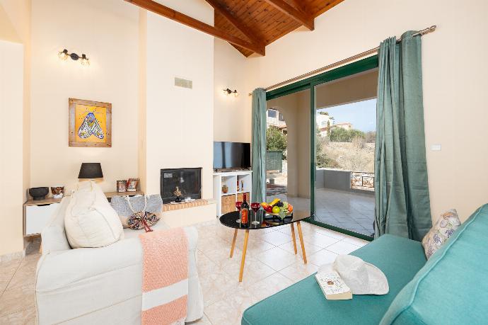 Open-plan living room with sofas, dining area, kitchen, ornamental fireplace, A/C, WiFi internet, and satellite TV . - Villa Phoebe . (Photo Gallery) }}