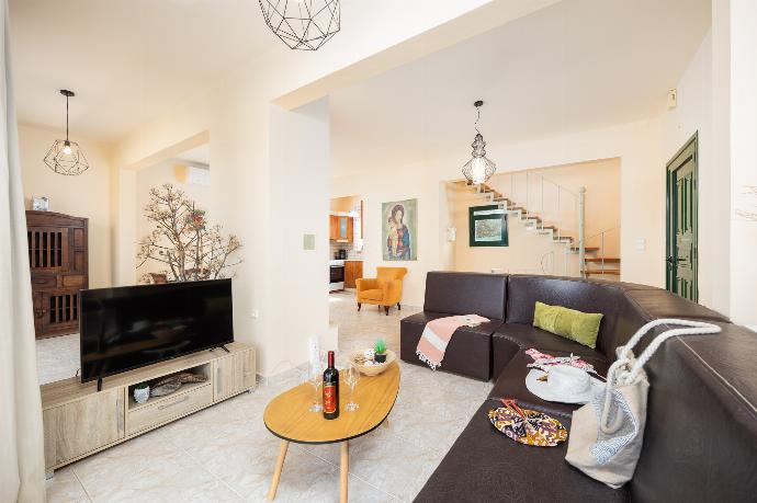 Open-plan living room with sofa, dining area, kitchen, ornamental fireplace, A/C, WiFi internet, and satellite TV . - Villa Phedra . (Photo Gallery) }}