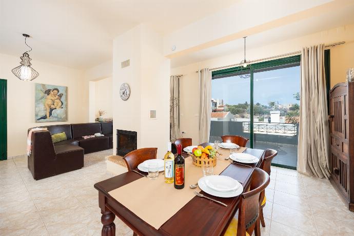 Open-plan living room with sofa, dining area, kitchen, ornamental fireplace, A/C, WiFi internet, and satellite TV . - Villa Phedra . (Photo Gallery) }}