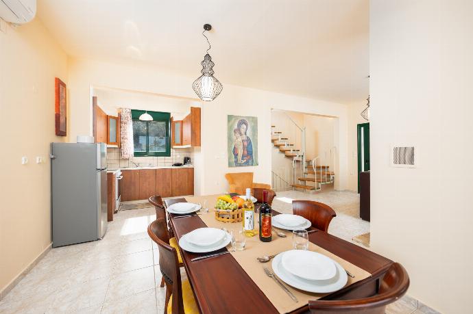 Open-plan living room with sofa, dining area, kitchen, ornamental fireplace, A/C, WiFi internet, and satellite TV . - Villa Phedra . (Photo Gallery) }}