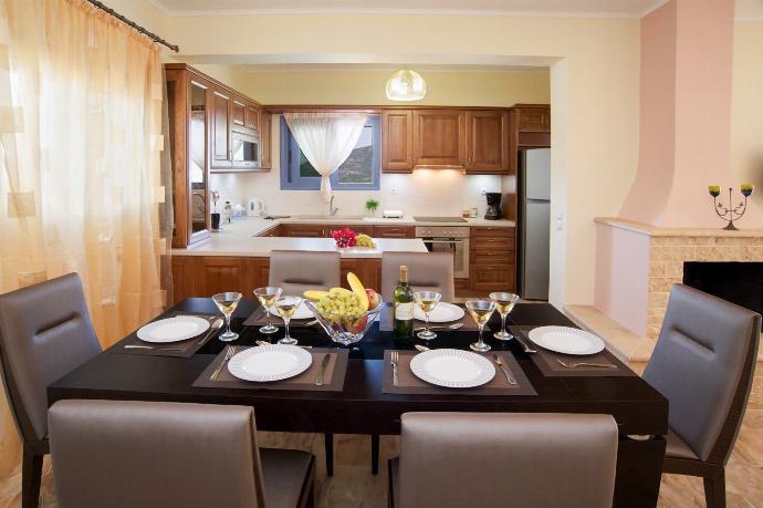 Open-plan living room with sofa, dining area kitchen, A/C, WiFi internet, and satellite TV . - Sunrise Villa . (Photo Gallery) }}