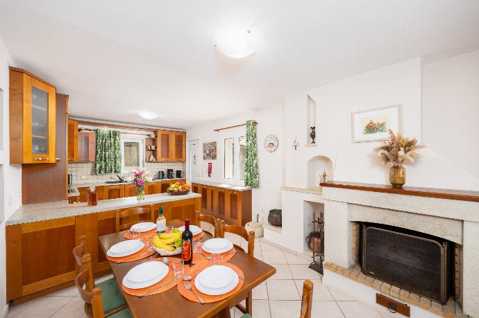 Dining area with A/C, sofa, and ornamental fireplace . - Villa Korini . (Photo Gallery) }}