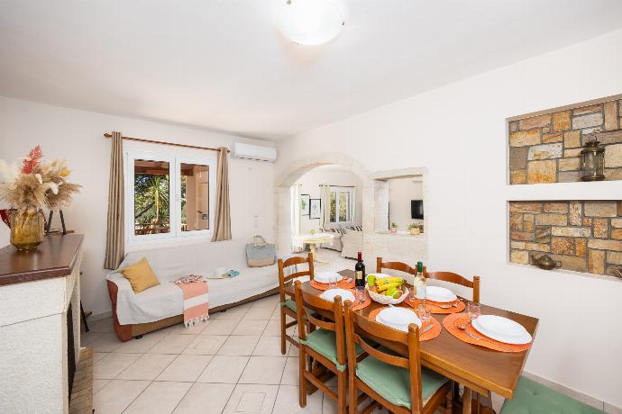 Dining area with A/C, sofa, and ornamental fireplace . - Villa Korini . (Photo Gallery) }}