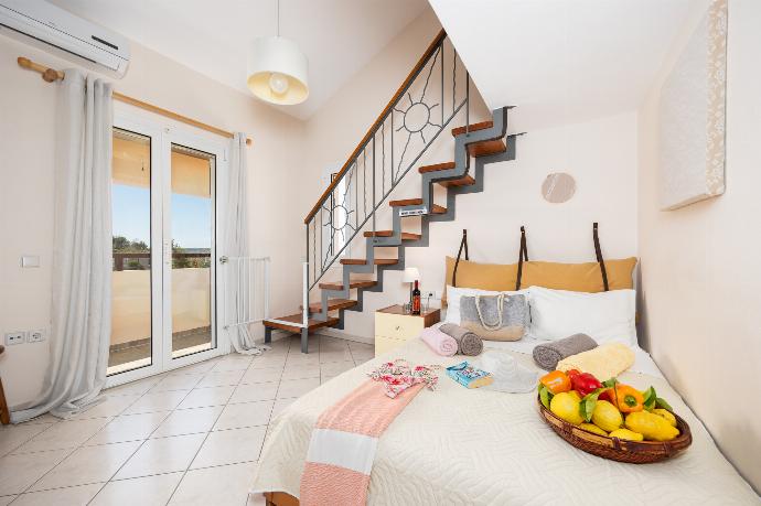 Double bedroom with mezzanine and A/C . - Villa Korini . (Photo Gallery) }}