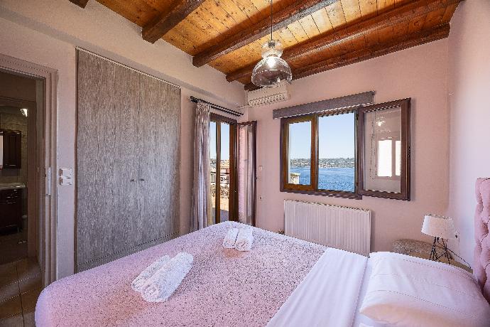 An alternate bedroom interior within the villa, showcasing a softer color scheme and expansive coastal views. . - Villa Forteza . (Photo Gallery) }}