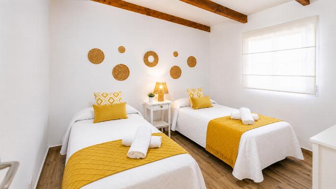 A bright twin bedroom with cheerful yellow accents and natural woven decor. . - Villa Casa Romero . (Photo Gallery) }}