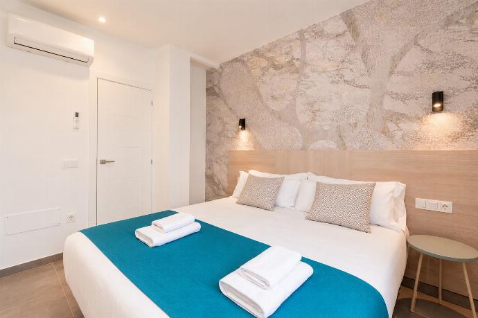 Bright double bedroom with elegant neutral decor and a spacious built-in wardrobe. . - Ereza Residence 1.4 . (Photo Gallery) }}