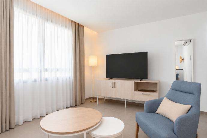 A modern open-plan living and dining area with elegant neutral decor. . - Ereza Residence 1.4 . (Photo Gallery) }}