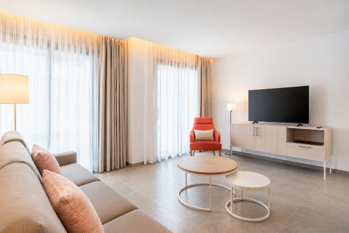 A bright modern open-plan living area with a stylish kitchen, dining space. . - Ereza Residence 2.1 . (Photo Gallery) }}