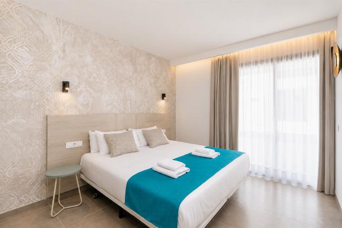Bright double bedroom with elegant neutral decor and a spacious built-in wardrobe. . - Ereza Residence 2.1 . (Photo Gallery) }}
