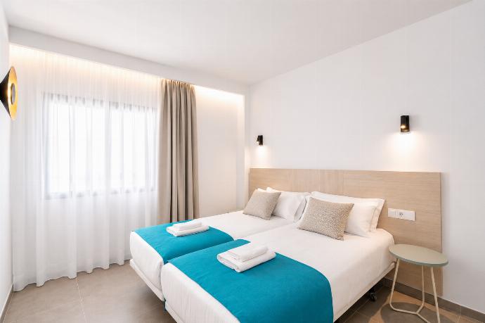 Bright twin bedroom with soft neutral tones, and warm natural light. . - Ereza Residence 2.1 . (Photo Gallery) }}