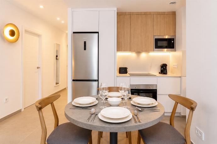 A bright modern open-plan living area with a stylish kitchen, dining space. . - Ereza Residence 2.2 . (Photo Gallery) }}