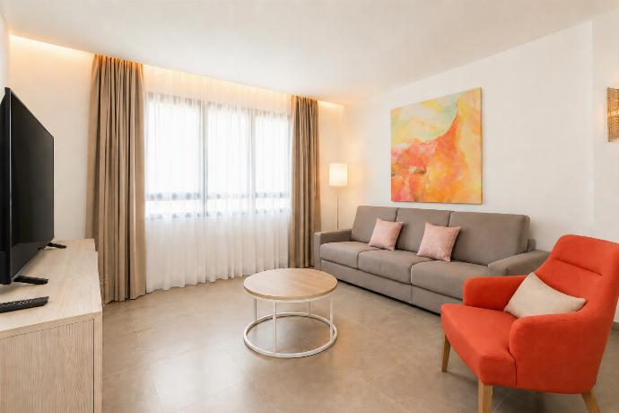 A modern open-plan living and dining area with elegant neutral decor. . - Ereza Residence 2.3 . (Photo Gallery) }}