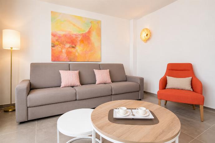 A modern open-plan living and dining area with elegant neutral decor. . - Ereza Residence 2.3 . (Photo Gallery) }}