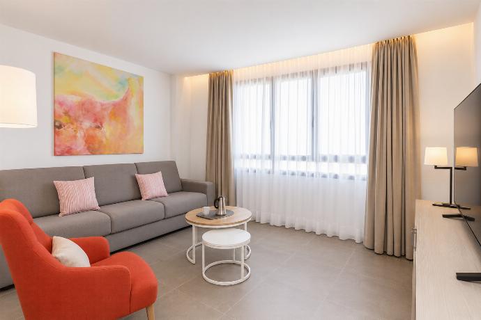 A modern open-plan living and dining area with elegant neutral decor. . - Ereza Residence 2.4 . (Photo Gallery) }}