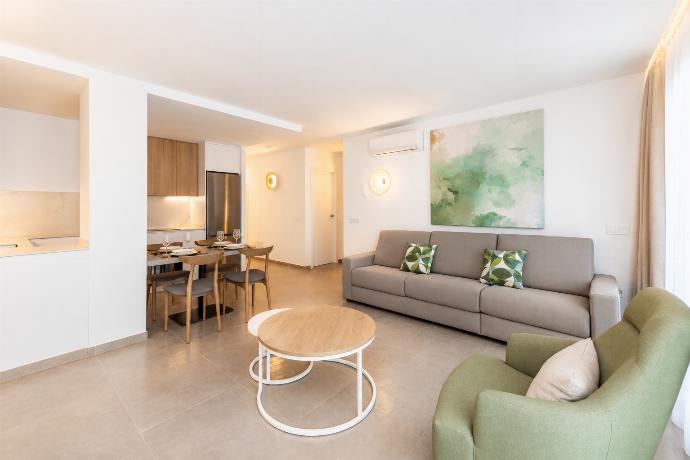 A modern open-plan living and dining area with elegant neutral decor. . - Ereza Residence 3.1 . (Photo Gallery) }}