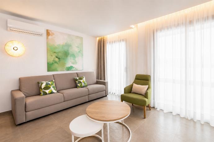 A modern open-plan living and dining area with elegant neutral decor. . - Ereza Residence 3.1 . (Photo Gallery) }}